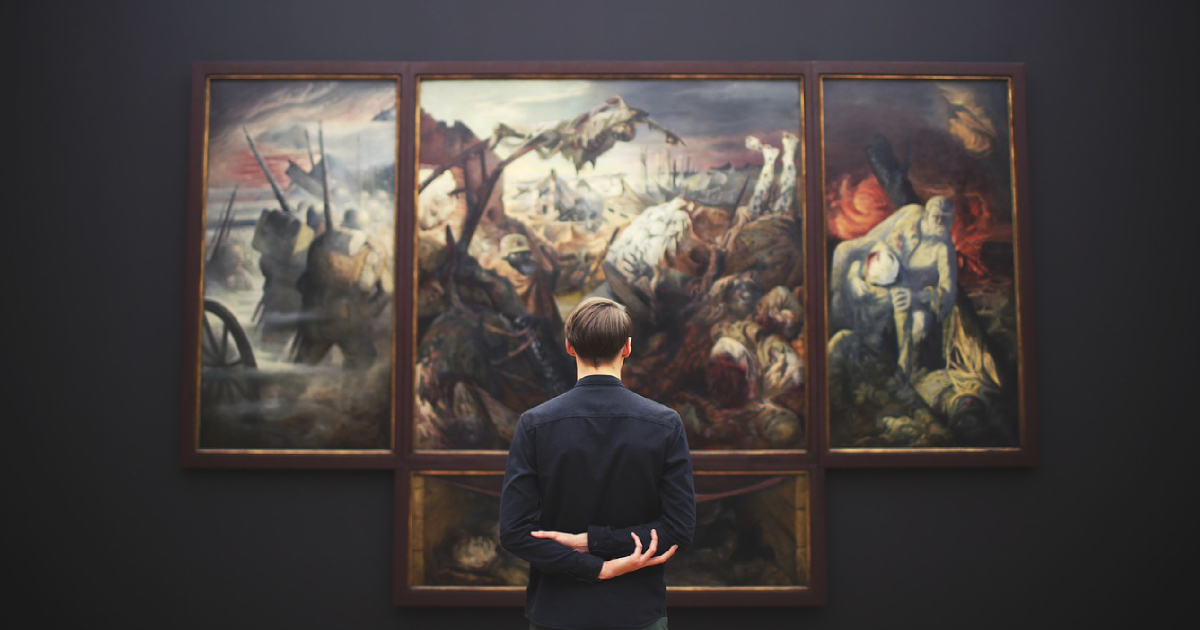 man staring at paintings inside a museum in lucid dreaming